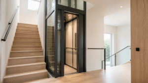 Modern residential elevator shaft with a glass enclosure beside a timber staircase